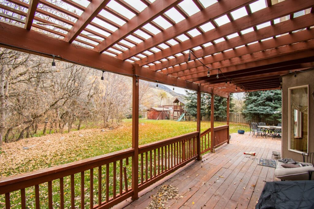 A beautiful wooden deck with autumn leaves, perfect for relaxing outdoors.