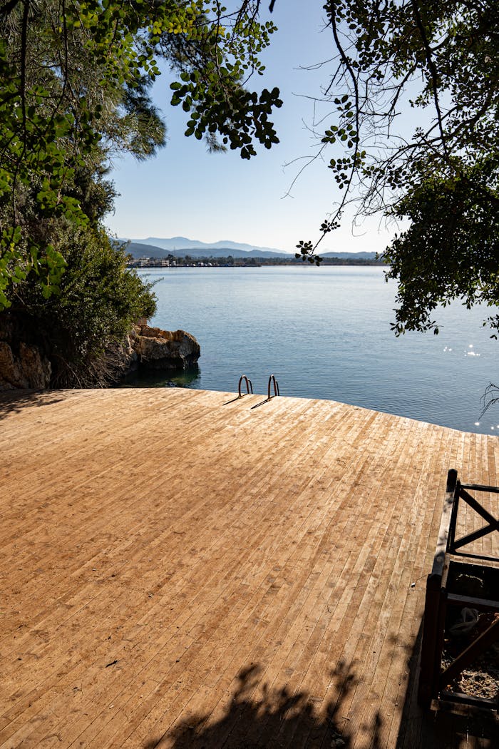 Peaceful lakeside deck with stunning water and mountain views, ideal for relaxation and nature appreciation.